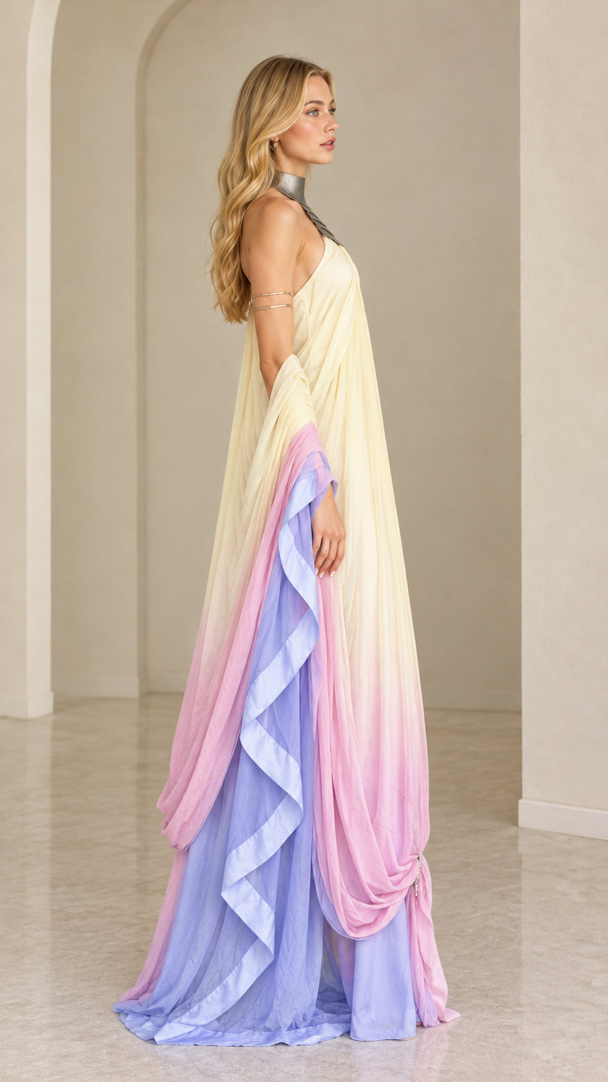 Side angle view of pastel ombre draped maxi gown showing flowing side silhouette