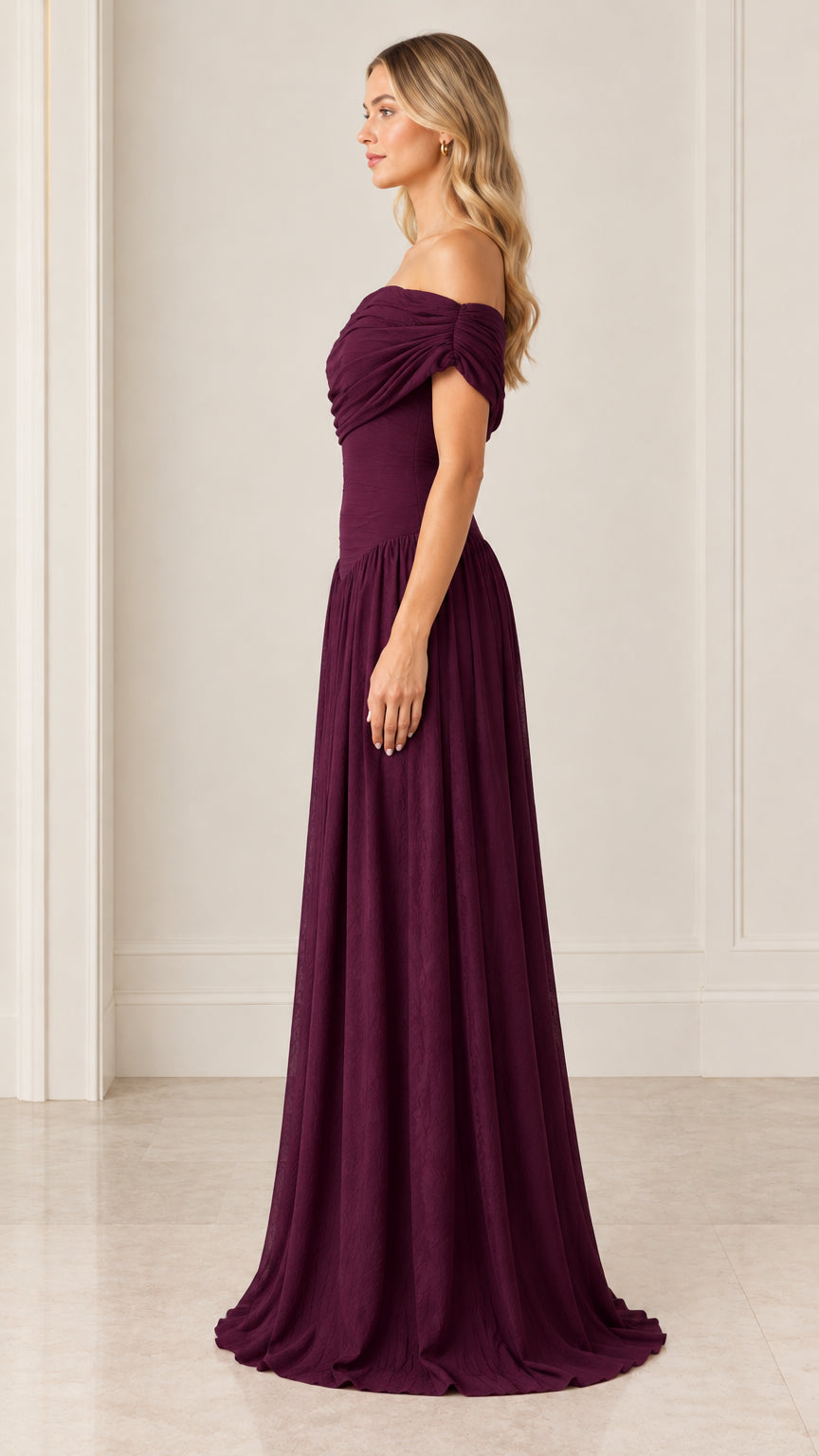 Side profile of burgundy draped off-the-shoulder formal evening dress