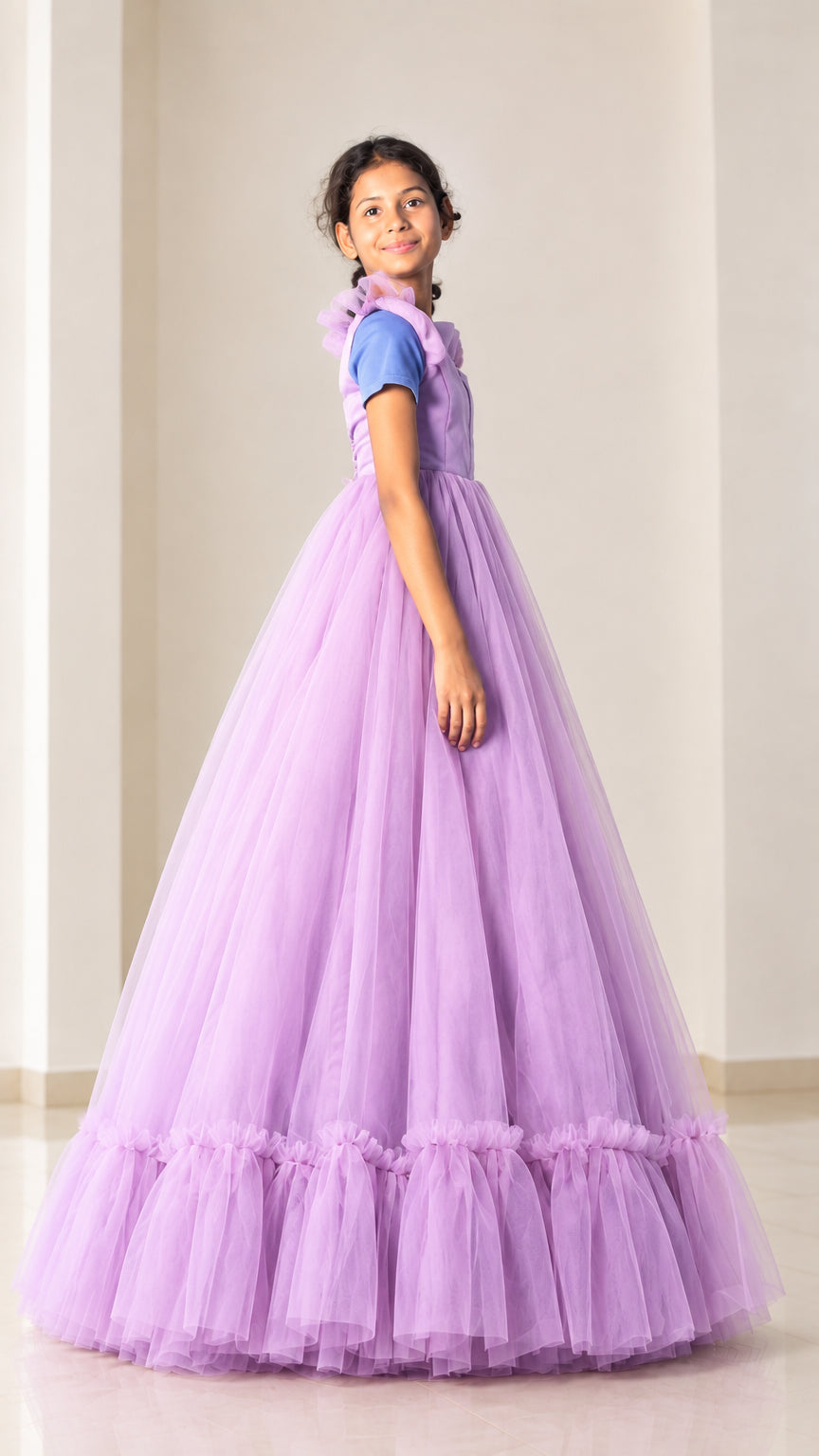 Side angle view of model posing in lilac tiered tulle floor-length evening dress