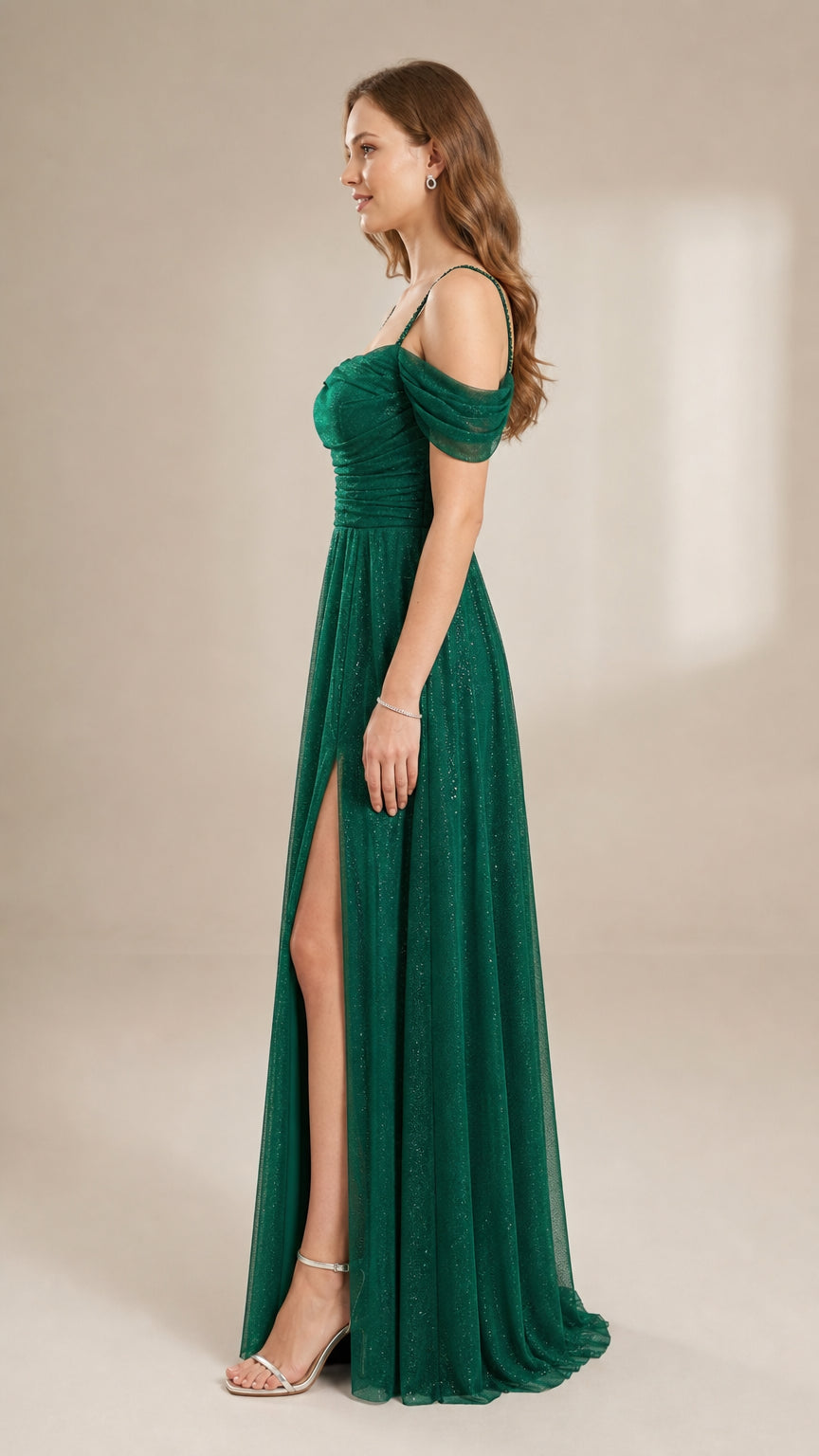 Side profile view of the emerald green glitter maxi dress showing the high leg slit and flowy skirt