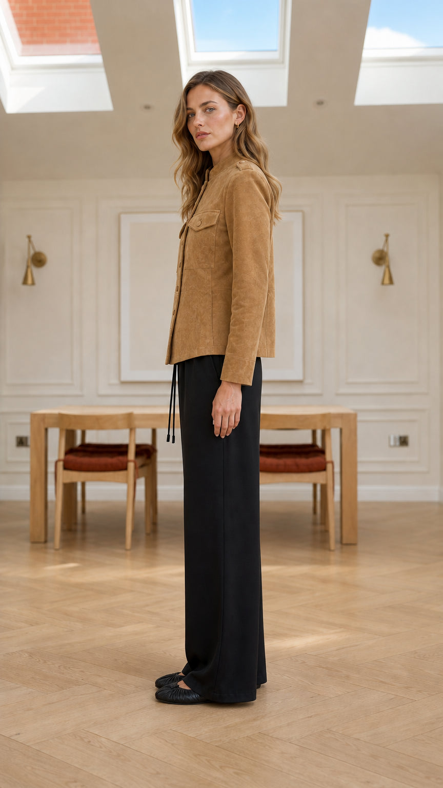 Side full-length view of model wearing camel faux suede stand collar jacket
