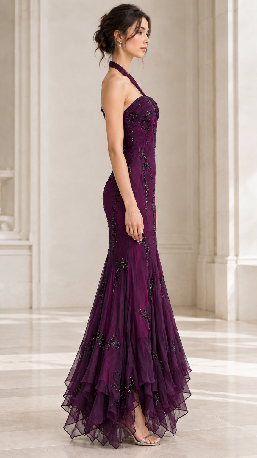 Side profile of woman in plum halter neck formal dress showing fitted mermaid silhouette