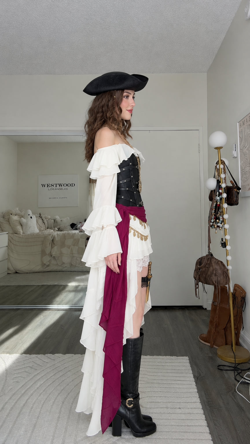 Side angle view of white pirate costume dress showing high-low ruffled hem and lace overlay