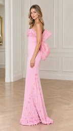 Side full view of woman wearing pink strapless mermaid gown with oversized back bow