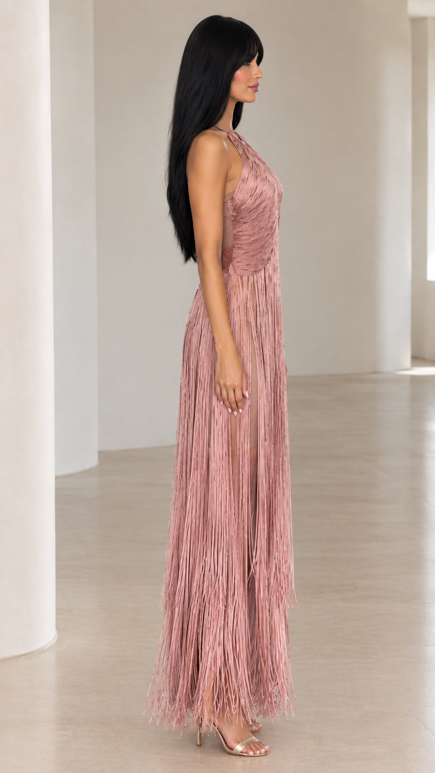 Side profile of woman in dusty rose sleeveless fringe evening gown