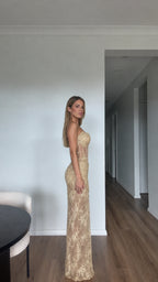 Side profile of model wearing Champagne Gold strapless corset maxi evening dress
