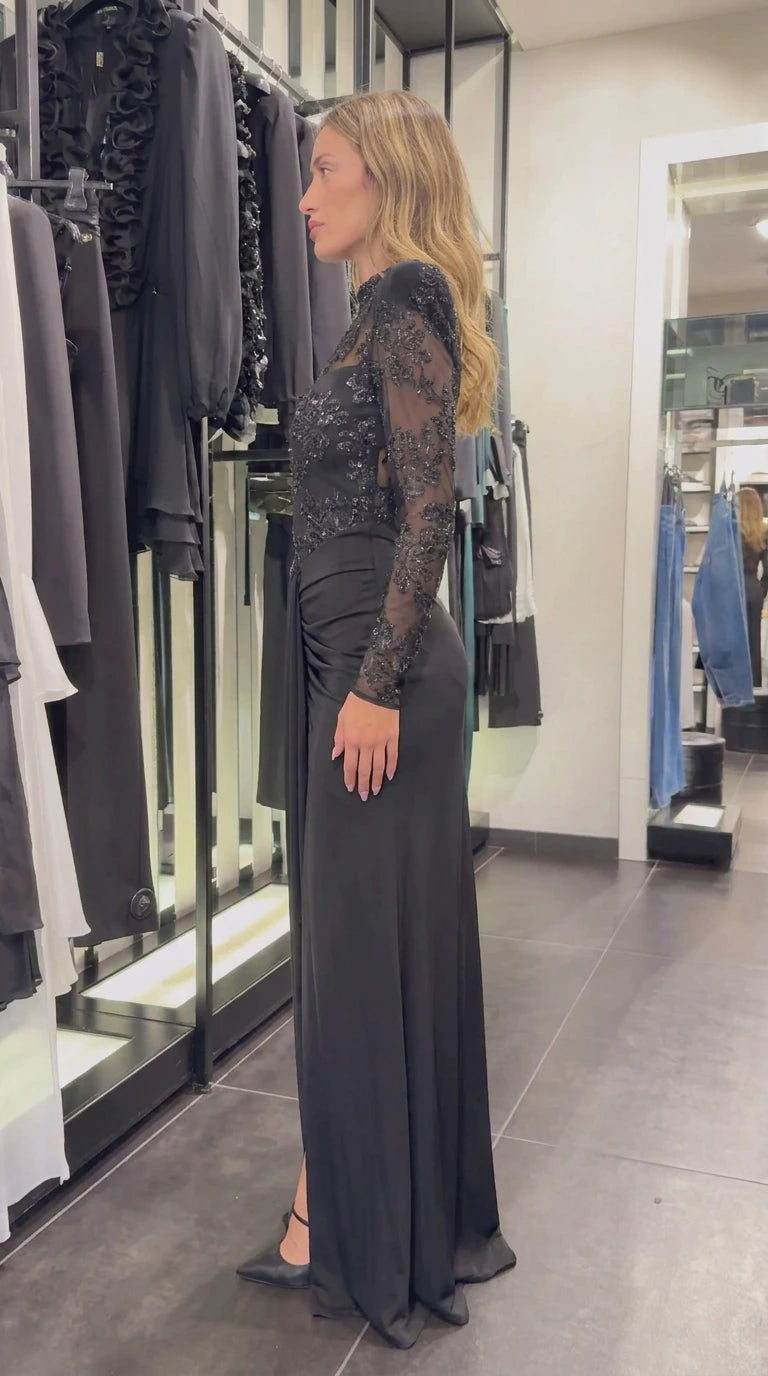 Side view of black floral embellished floor-length evening dress