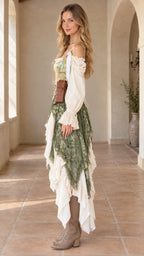 Side profile view of model showcasing the asymmetrical hem and ruffled sleeves of the olive green Renaissance dress