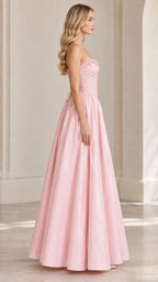 Side profile view of model in light pink strapless lace-up ball gown