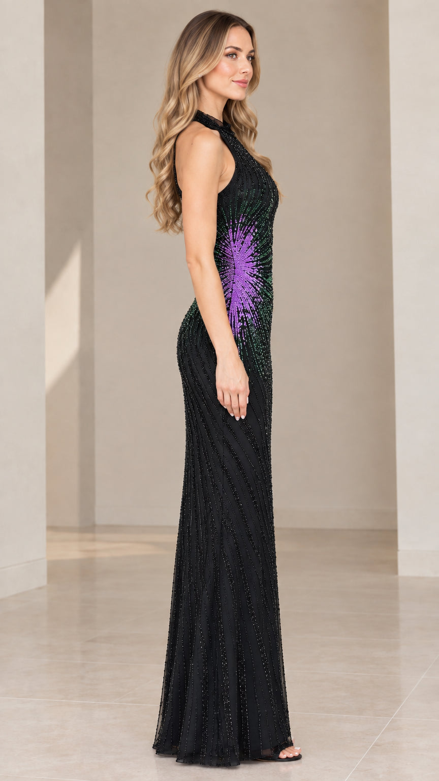 Side profile of woman wearing black beaded halter column gown with purple hip accent