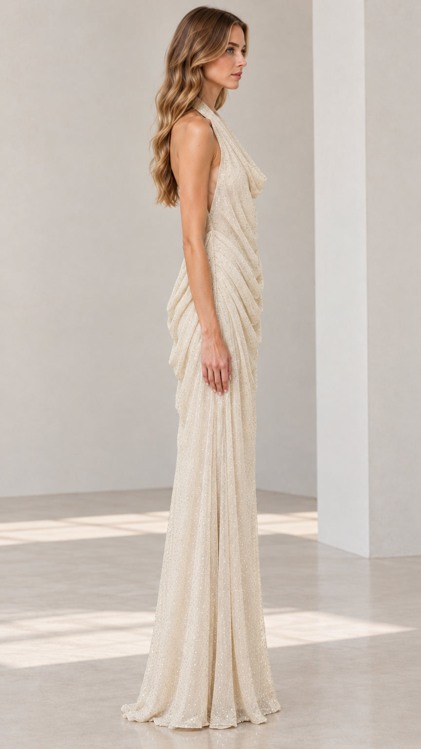 Side angle view of Champagne draped halter maxi dress showcasing ruched silhouette