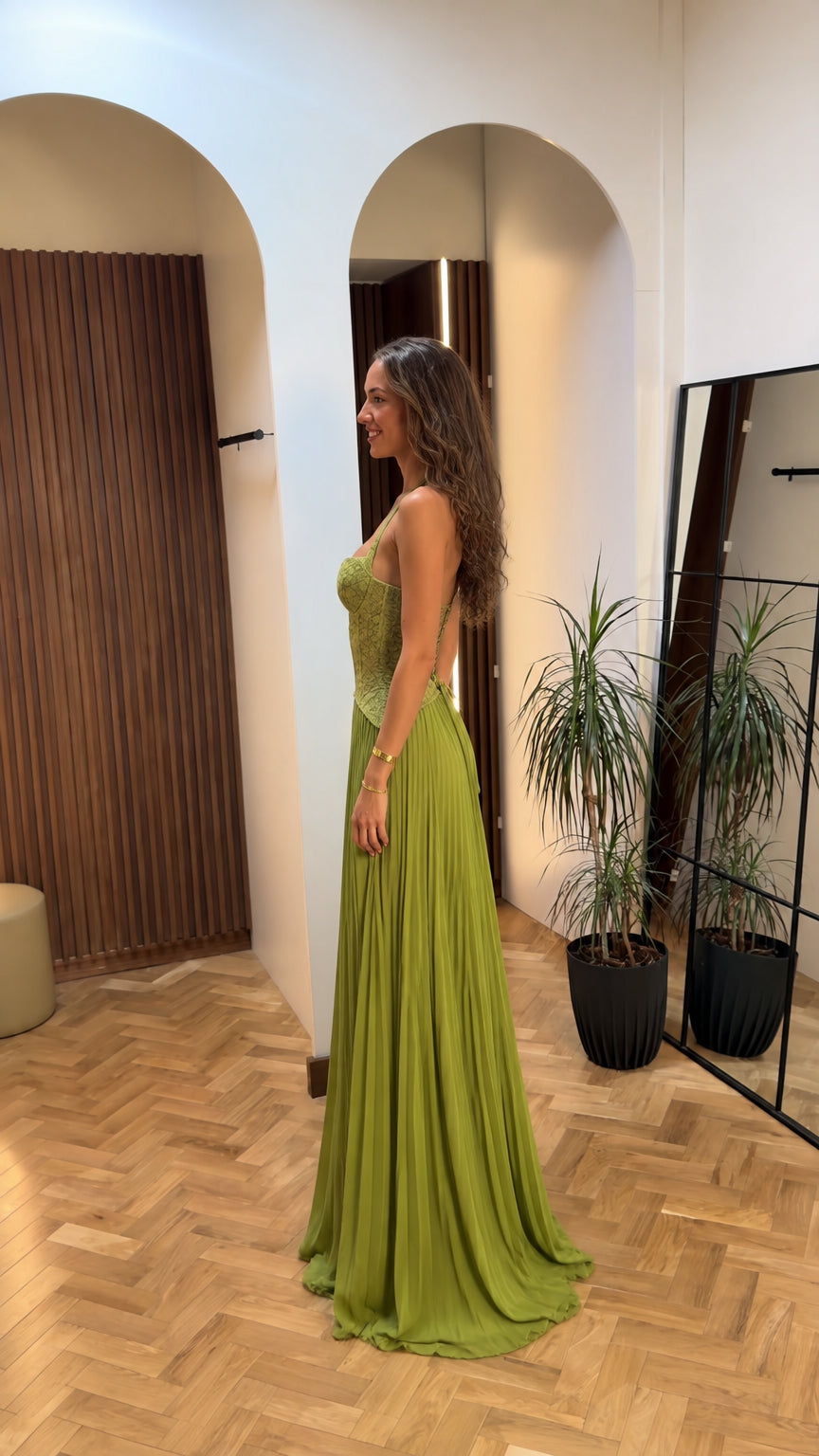 Side profile of olive green lace halter pleated evening maxi dress