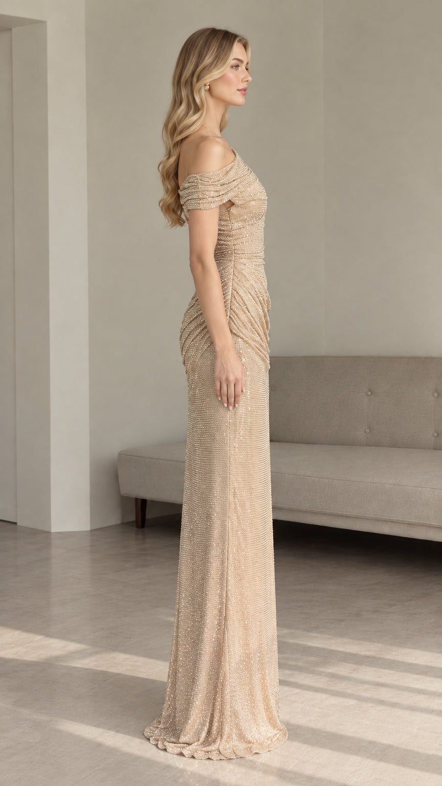 Side profile view of gold one-shoulder sequin column formal gown showing elegant floor length drape