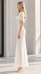 Side profile of model in the Ivory floor-length beaded capelet gown