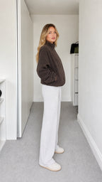 Side profile view of dark brown relaxed fit fleece jacket
