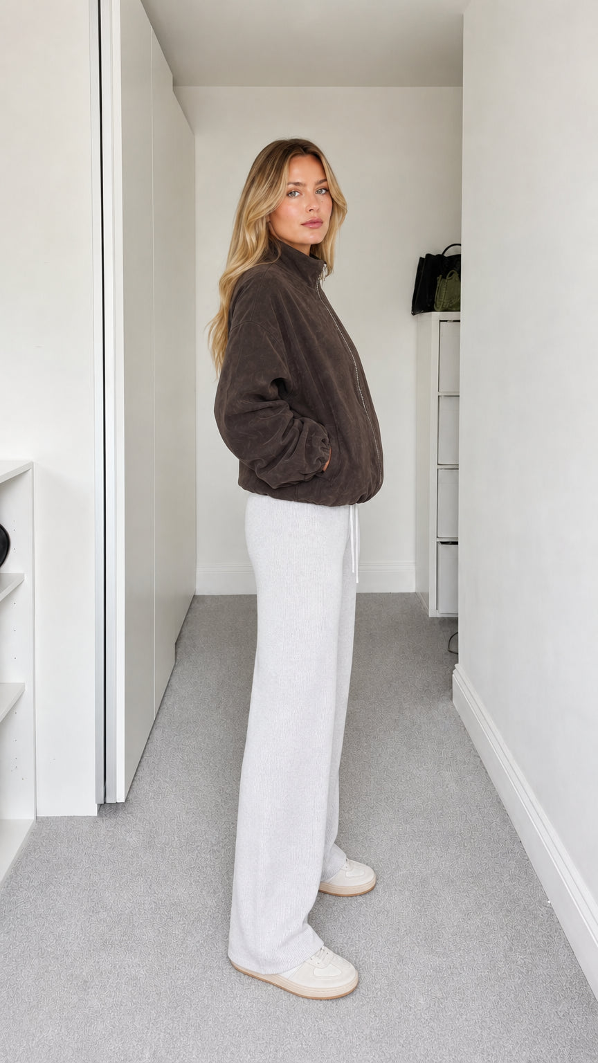 Side profile view of dark brown relaxed fit fleece jacket