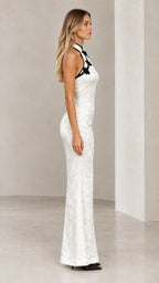 Side profile view of model wearing white backless cheongsam inspired floor length gown