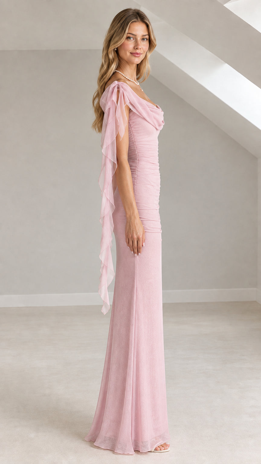 Side profile view of a model in a dusty pink ruched formal evening gown with cowl neckline