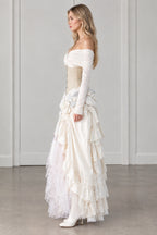 Side profile of model wearing ivory off-shoulder corset tiered gown