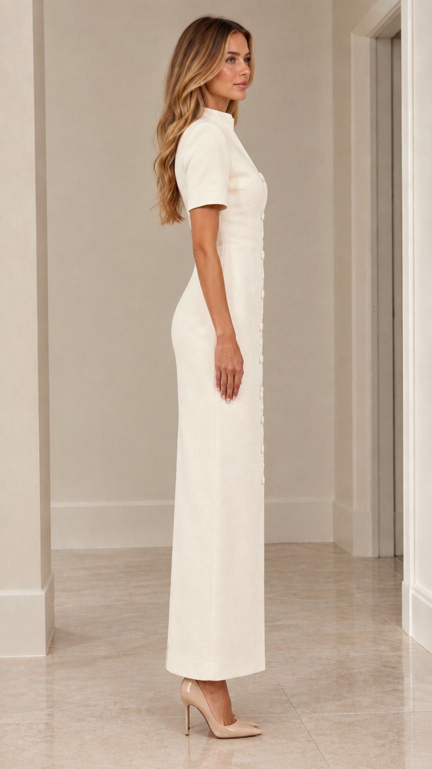 Side profile view of woman wearing ivory short sleeve column dress