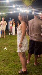 Side angle of white crochet disc sequin backless mini dress