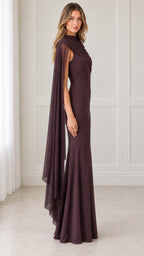 Side profile view of model in deep plum draped cape sleeve formal gown