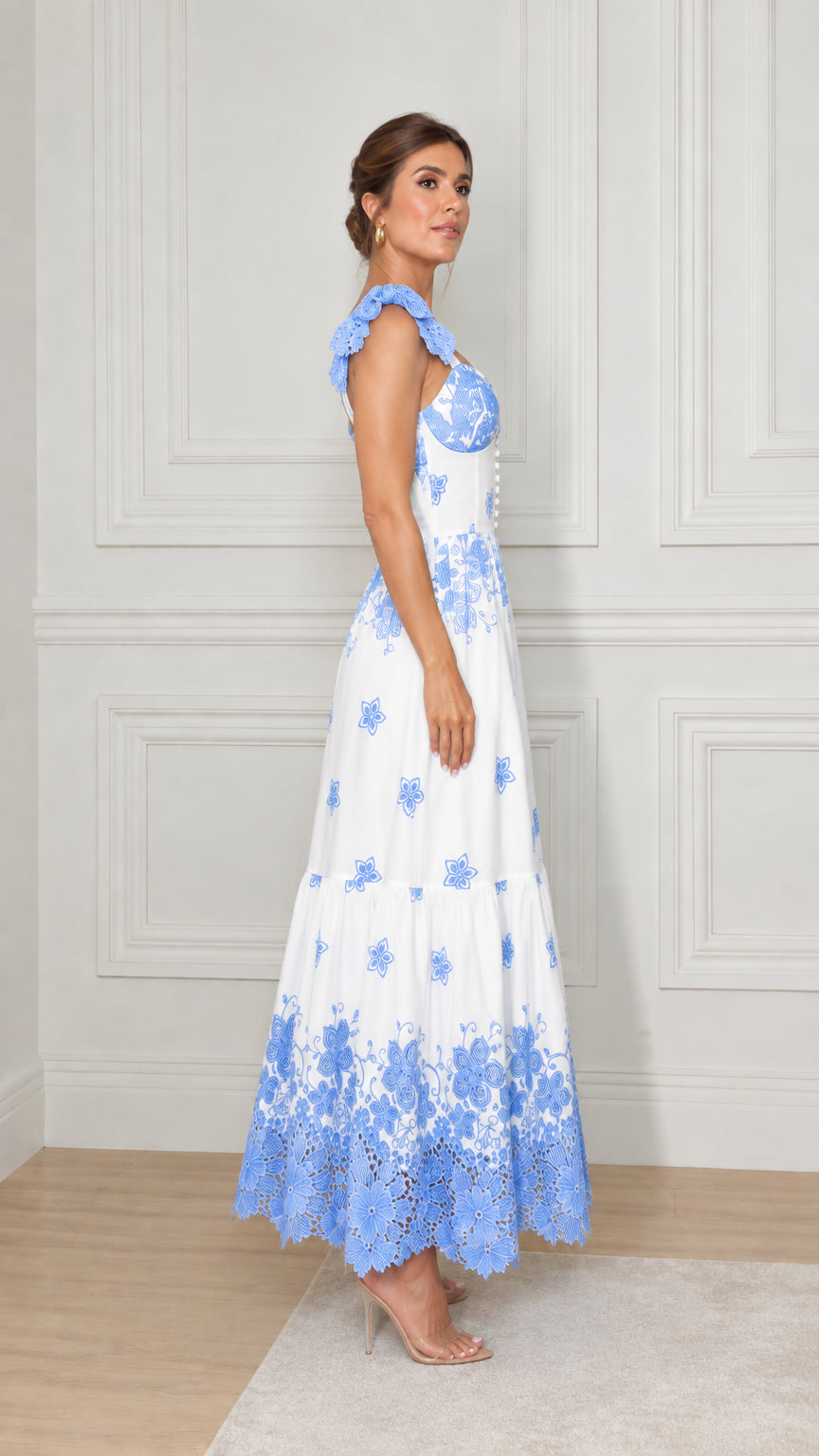 Side profile view of white and blue embroidered tiered A-line maxi dress