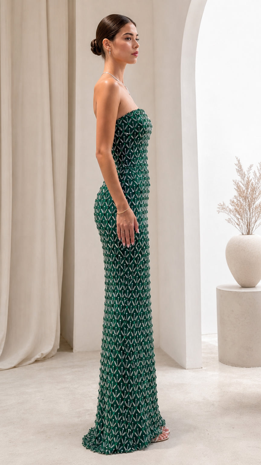 Side view of model wearing Emerald Green strapless beaded maxi gown