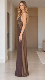 Side profile view of woman wearing brown backless satin maxi slip dress