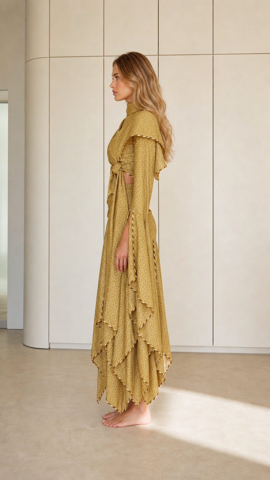 Side profile of Olive Gold draped maxi dress showing ruched fit and ruffled layers