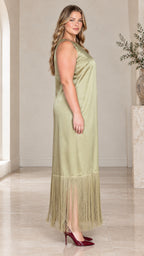 Side profile view of woman wearing sage green satin dress with long fringe trim