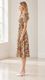 Side full-length view of sage green floral wrap midi dress showing tie waist
