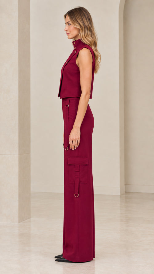 Side profile view of burgundy high-neck vest and wide-leg cargo pants two-piece set