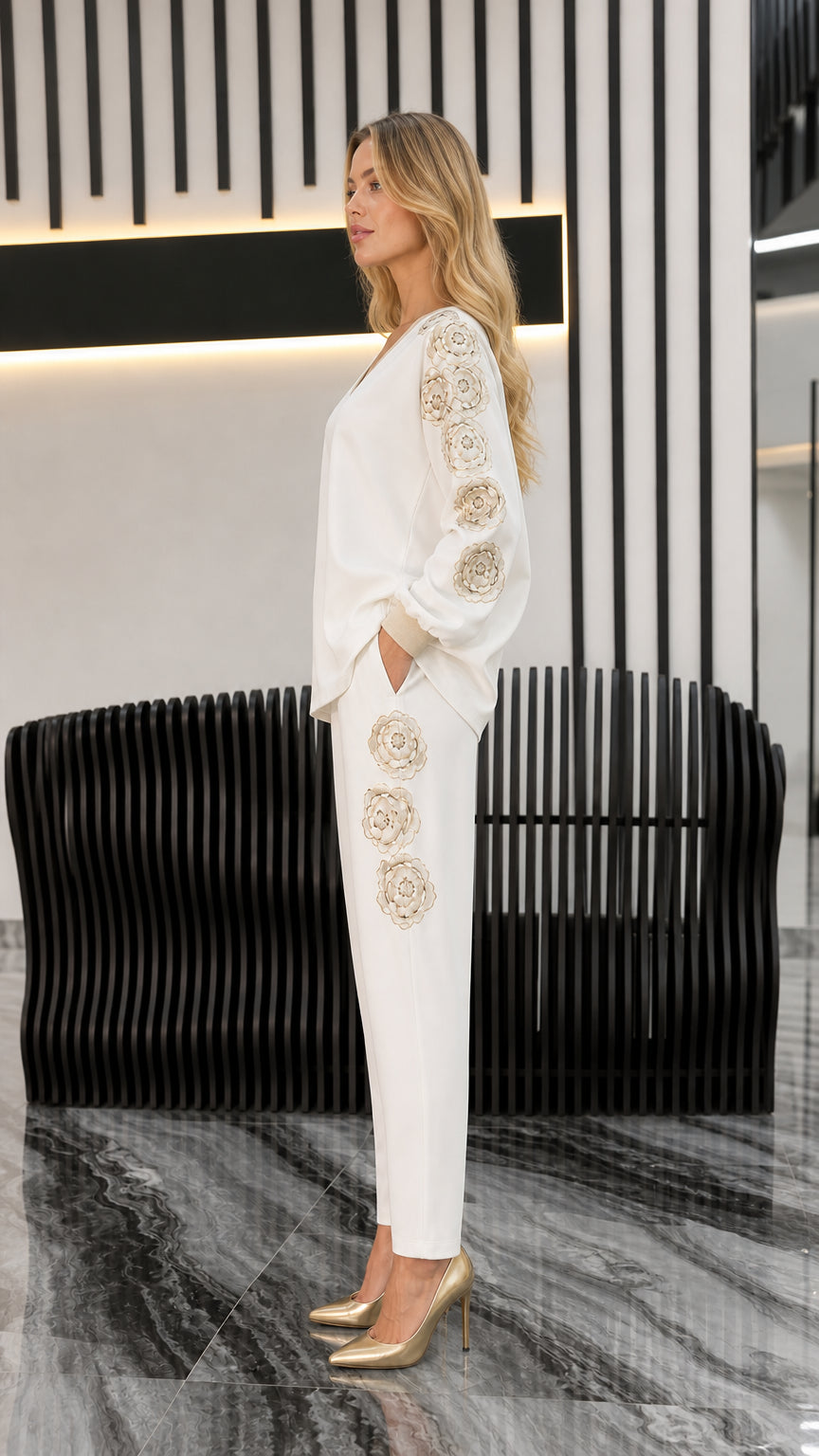 Side profile view of ivory matching set highlighting floral embroidery on sleeve and pants