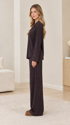 Side profile view of model wearing dark brown relaxed fit pajama set