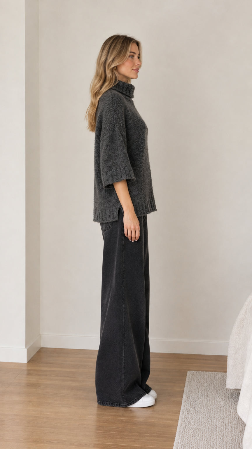 Side profile view of dark grey turtleneck sweater with elbow-length sleeves