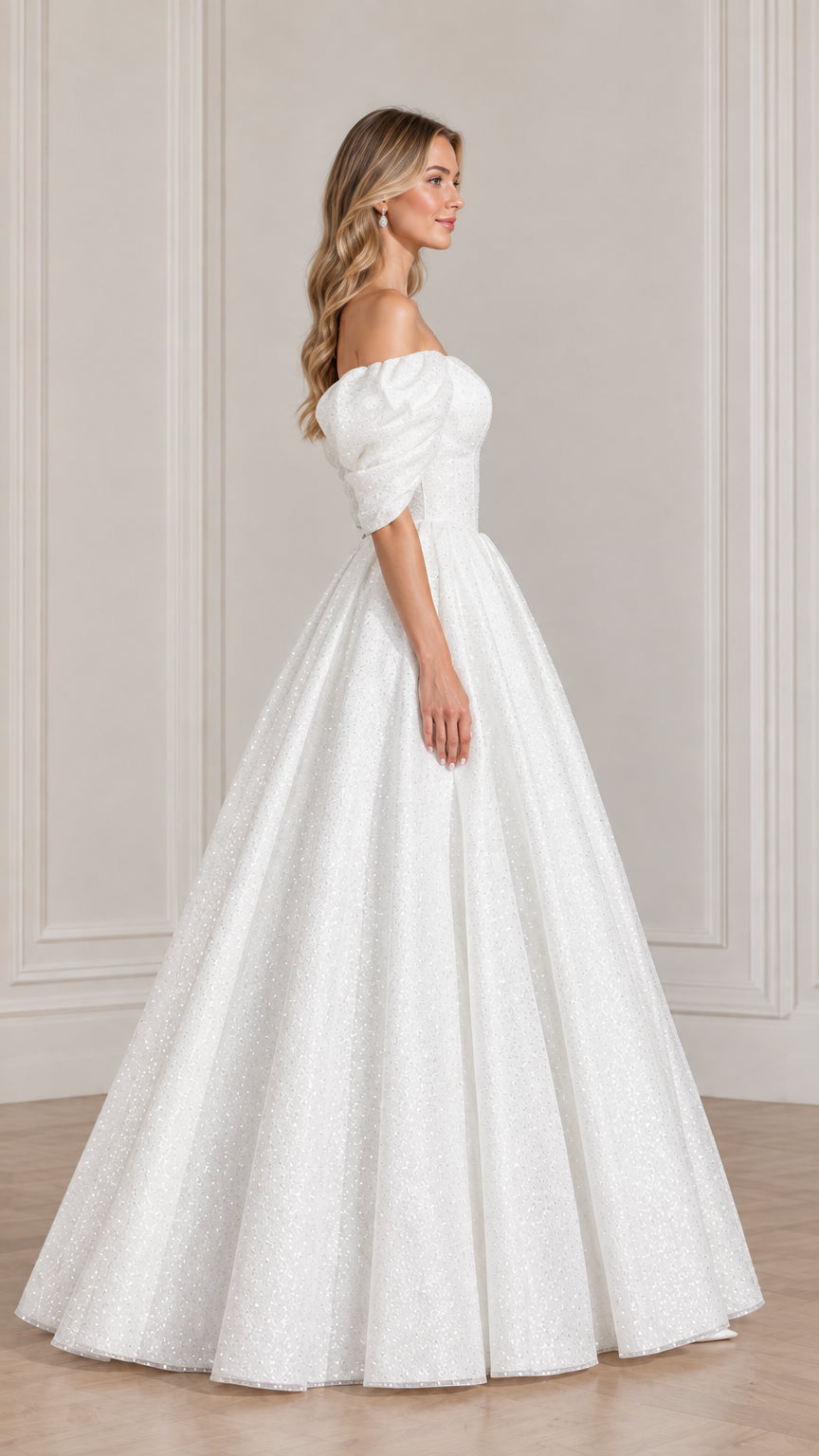 Side profile of model in sparkling white off-the-shoulder evening ball gown