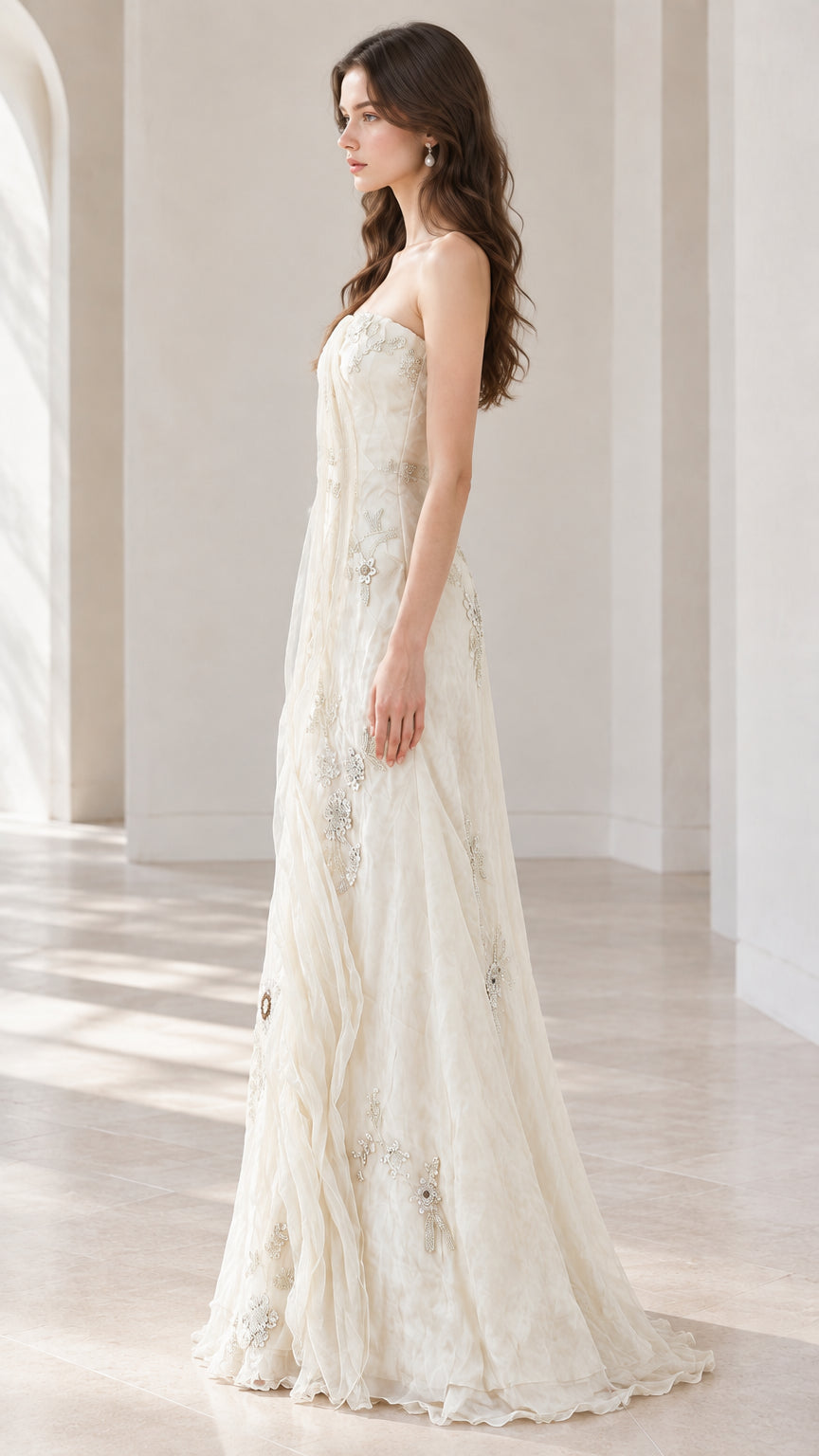 Side profile view of ivory strapless formal maxi gown showing fit and drape