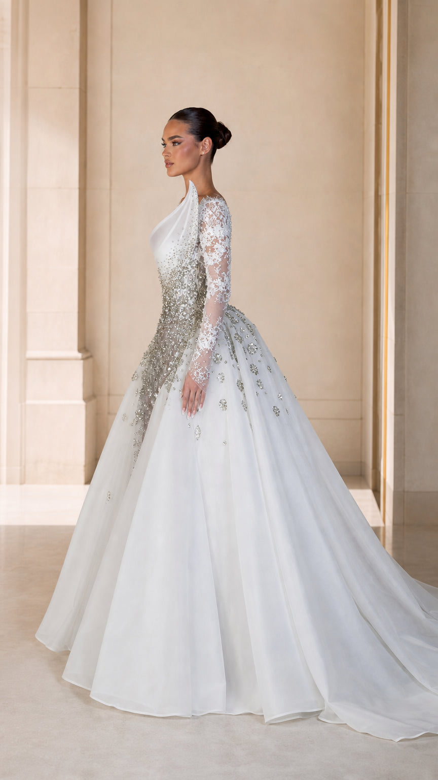 Side profile of white embellished long sleeve formal dress with voluminous train