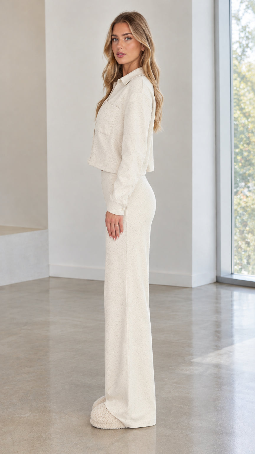Side profile view of woman wearing cream textured knit matching shirt and pants set