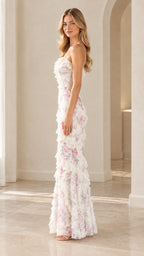 Side profile view of model wearing white floral lace ruffle tiered maxi dress