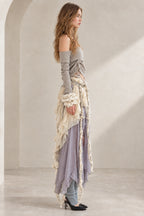 Side profile of model wearing Lavender Grey layered boho two-piece maxi skirt set