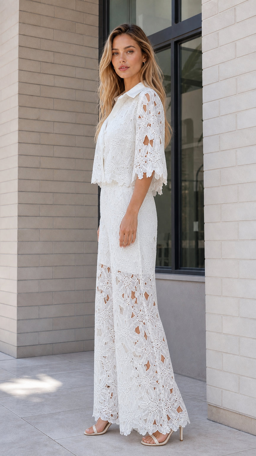 Side profile of model posing in white floral lace matching set