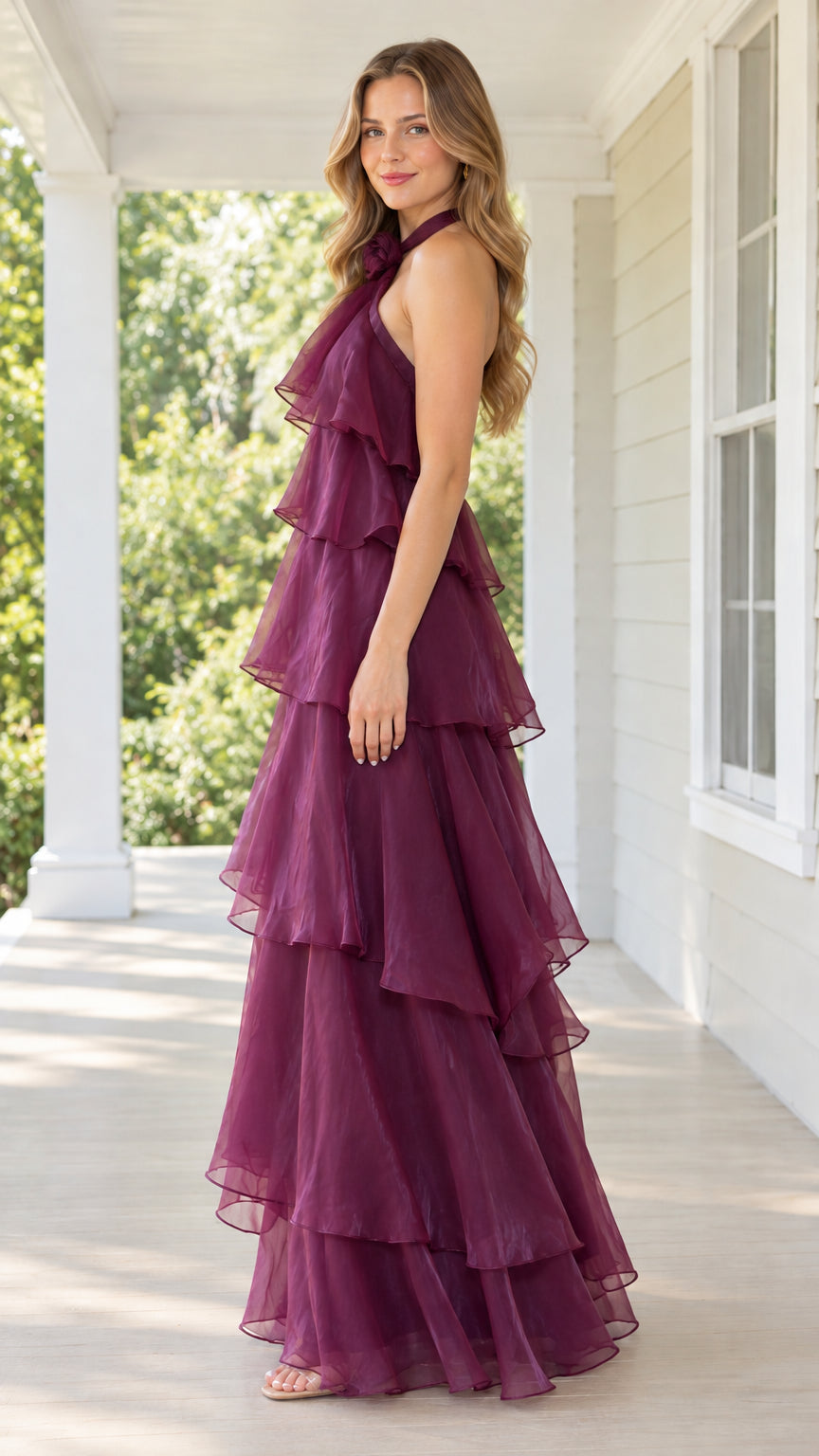 Side profile of burgundy tiered ruffle halter evening dress