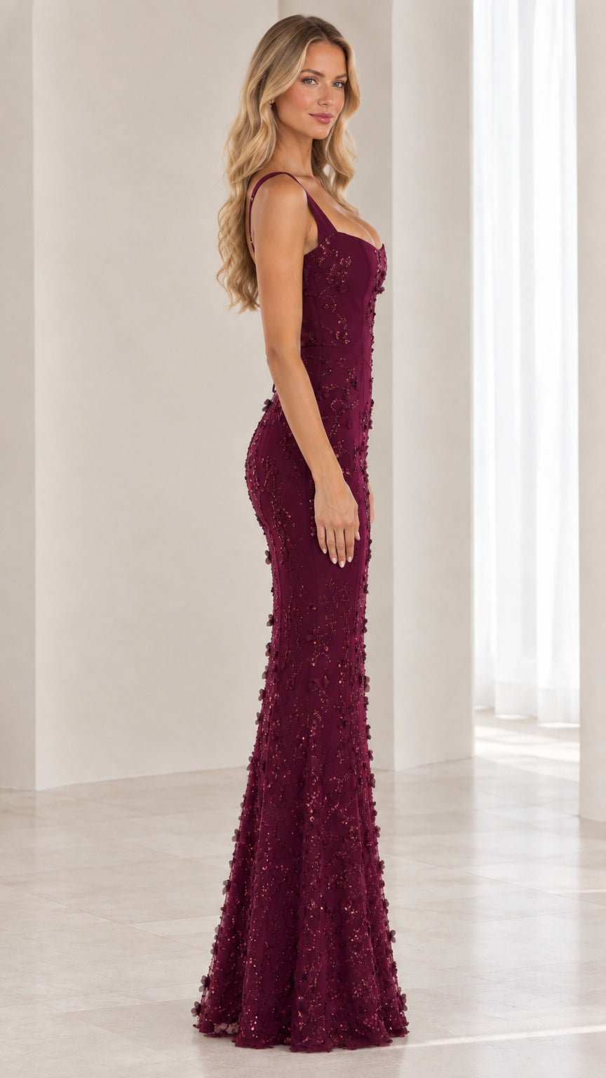 Side profile view of burgundy sequin floor-length formal gown with scoop neckline