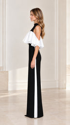 Side view of model wearing black and white ruffle trim column maxi dress