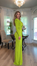 Side profile view showing sleek fitted silhouette and structured shoulders of the lime green maxi dress