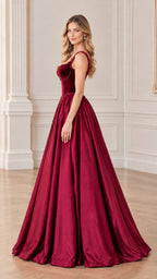 Side profile of burgundy formal ball gown with voluminous floor-length skirt