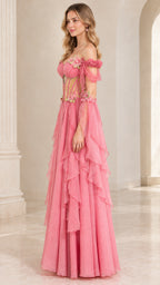 Side angle view of model wearing pink corset maxi dress with sheer draped bell sleeves
