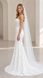 Side profile of bride in white lace corset mermaid wedding dress with sheer boning detail
